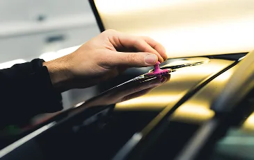 Glue tab placement on a vehicle panel